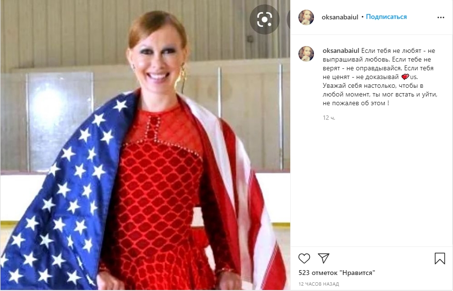 Фото: спортсменка стоит, укутанная флагом Америки